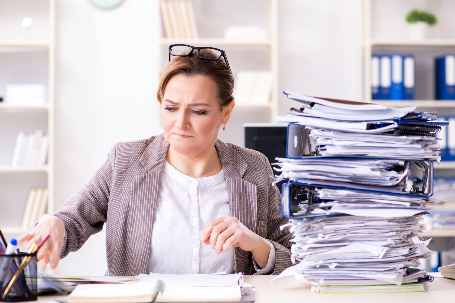 Employee's desk overflowing with paperwork